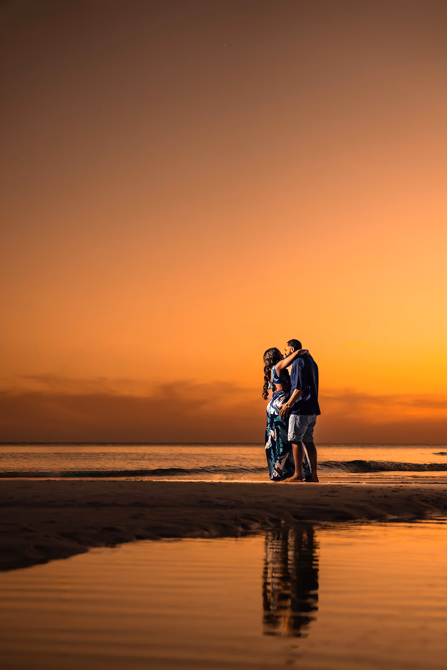 Bride and groom silhouetted at sunset by 8nfinity Photography