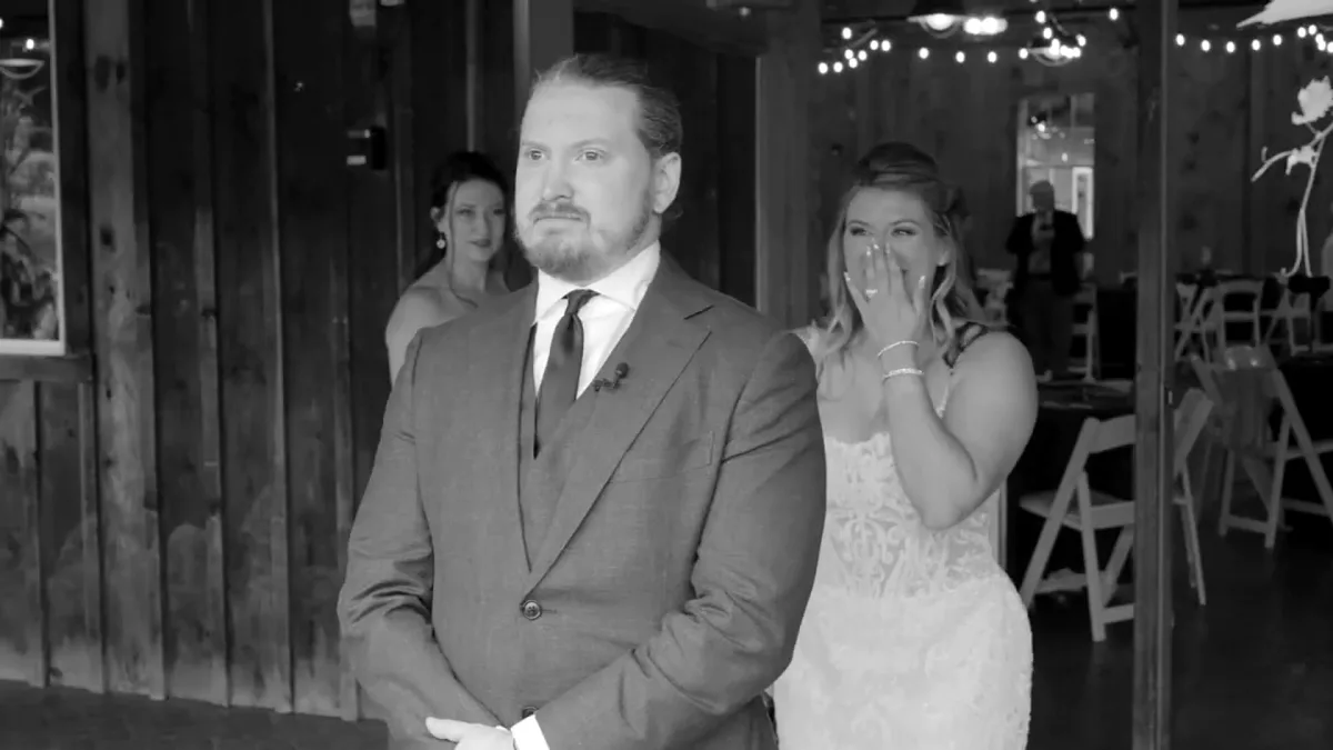 Black-and-white candid of a couple laughing together