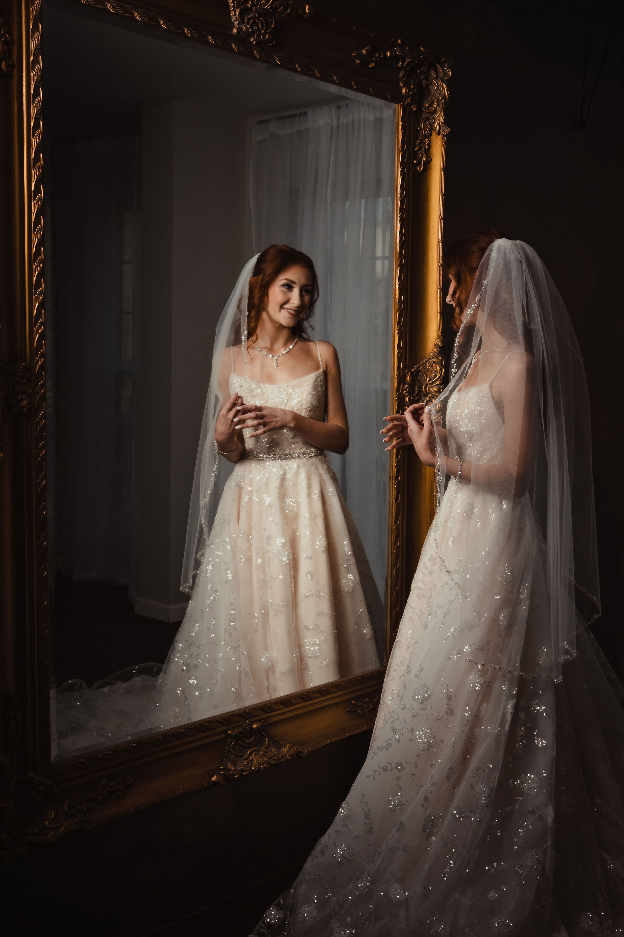 Bride reflected in a mirror before the wedding ceremony