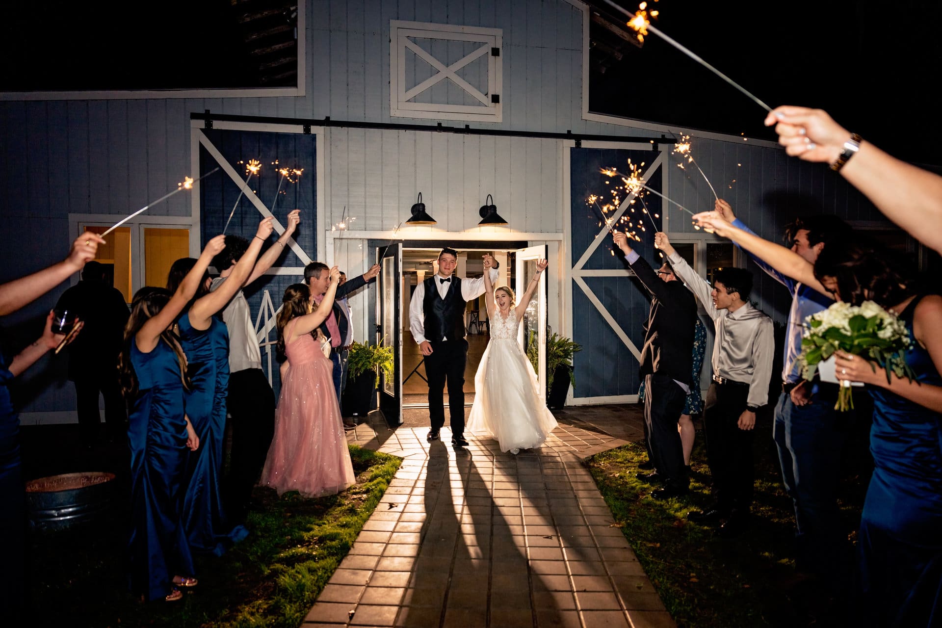 Julia and Evan celebrating at their wedding reception at The Barn at Crescent Lakes in Destin, Florida